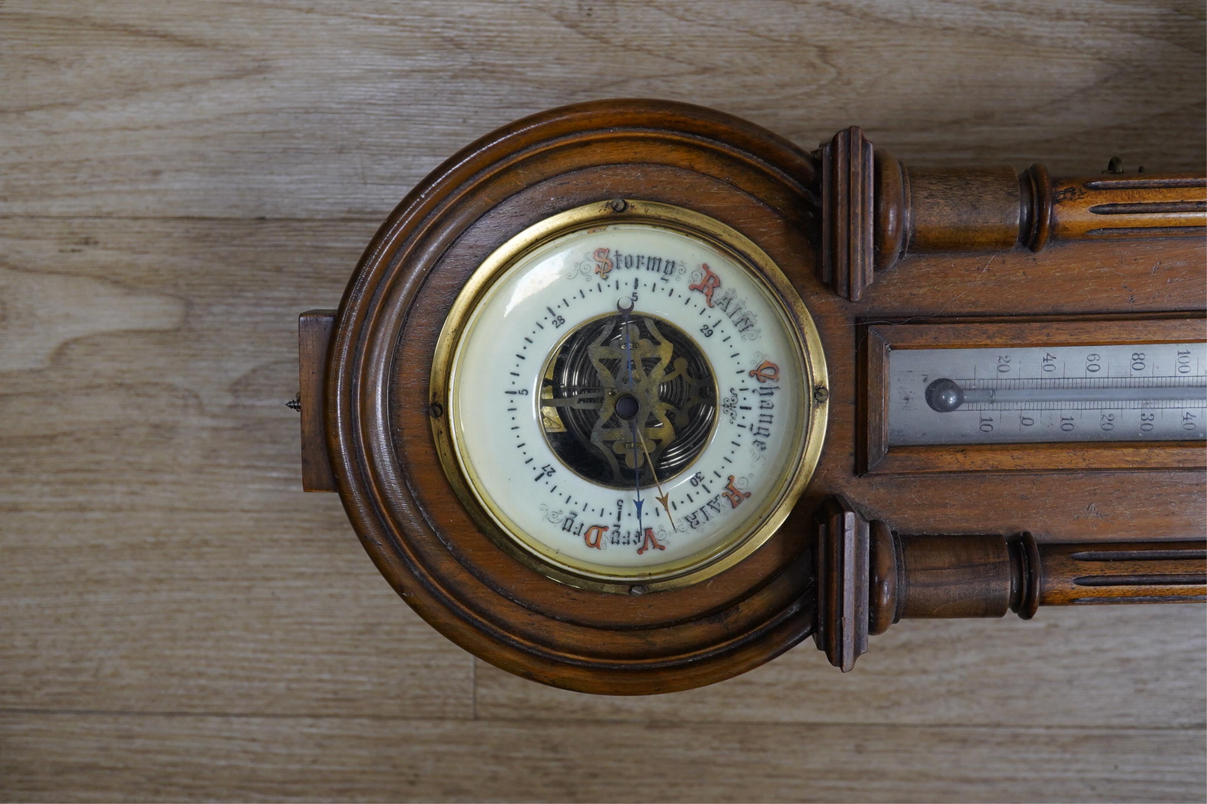 A late 19th century walnut wall clock, barometer and thermometer combination, striking on a coiled gong, 65cm high. Condition - fair, crack to the case and finial missing to the bottom